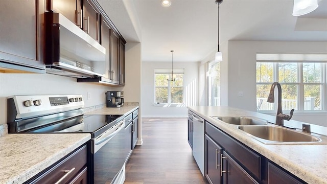 kitchen with sink, hanging light fixtures, stainless steel appliances, and a healthy amount of sunlight