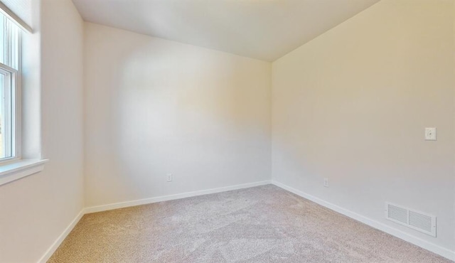 spare room with light carpet and a healthy amount of sunlight