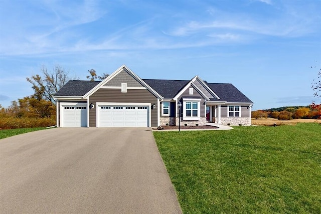 craftsman-style home featuring a front lawn and a garage