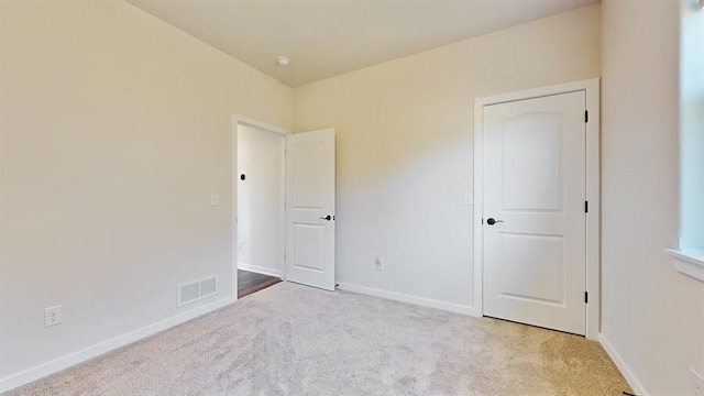 unfurnished bedroom with light carpet