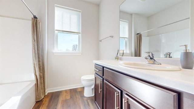 full bathroom featuring toilet, vanity, wood-type flooring, and shower / tub combo