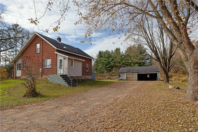 view of front of property featuring an outdoor structure and a garage