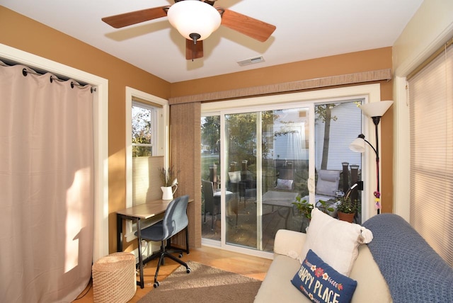 interior space with wood-type flooring and ceiling fan