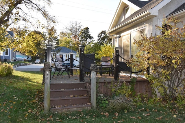 wooden terrace with a lawn