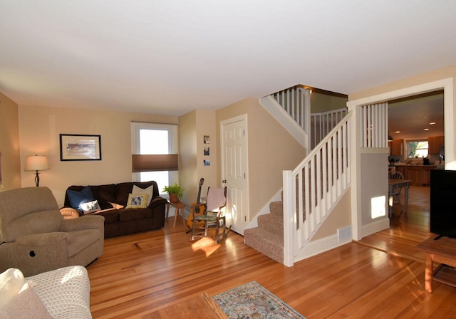 living room featuring light hardwood / wood-style flooring and a healthy amount of sunlight