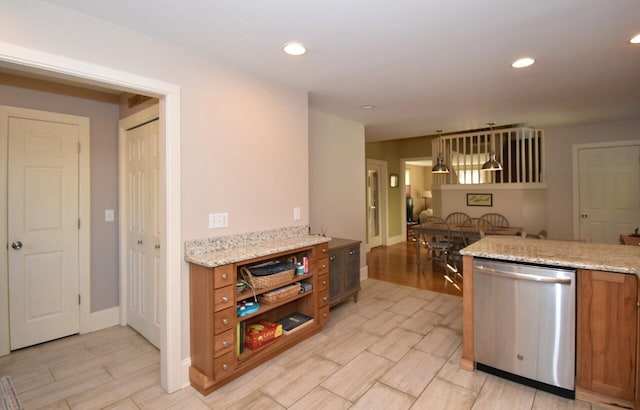 kitchen featuring stainless steel dishwasher, light stone countertops, and light hardwood / wood-style floors