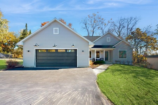 view of front of home featuring a front yard and a garage