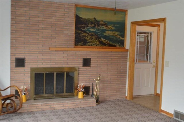 carpeted living room with a brick fireplace