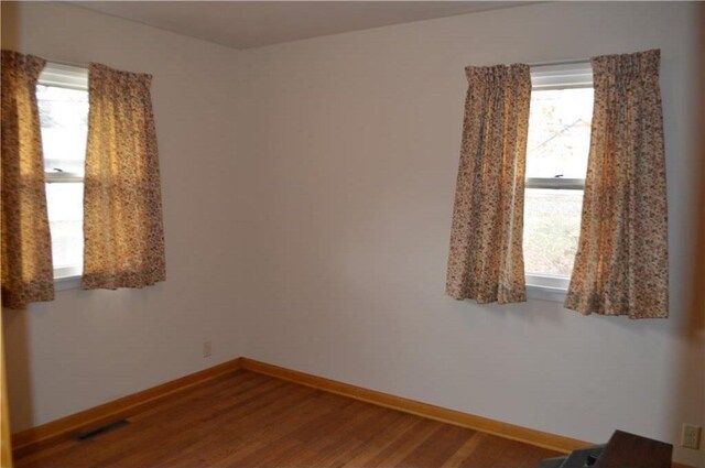 spare room with hardwood / wood-style flooring