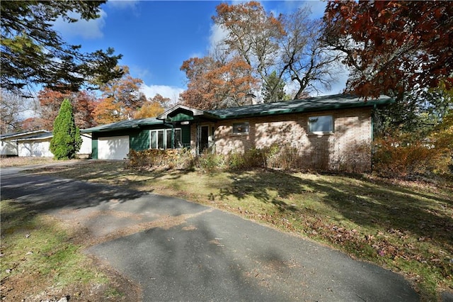 single story home with a front yard and a garage