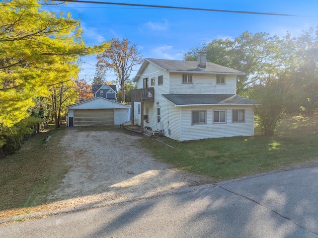 view of front of property featuring a garage, a front lawn, a balcony, a chimney, and an outbuilding