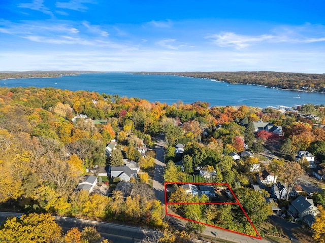 aerial view with a water view and a view of trees