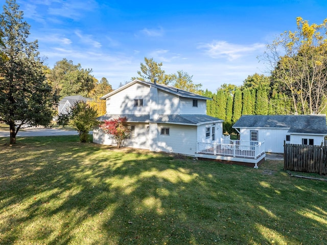back of house featuring a yard, a deck, and fence