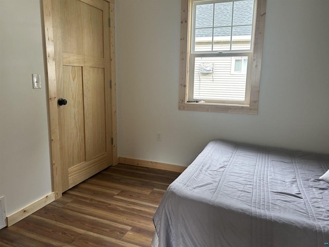 bedroom featuring dark hardwood / wood-style flooring