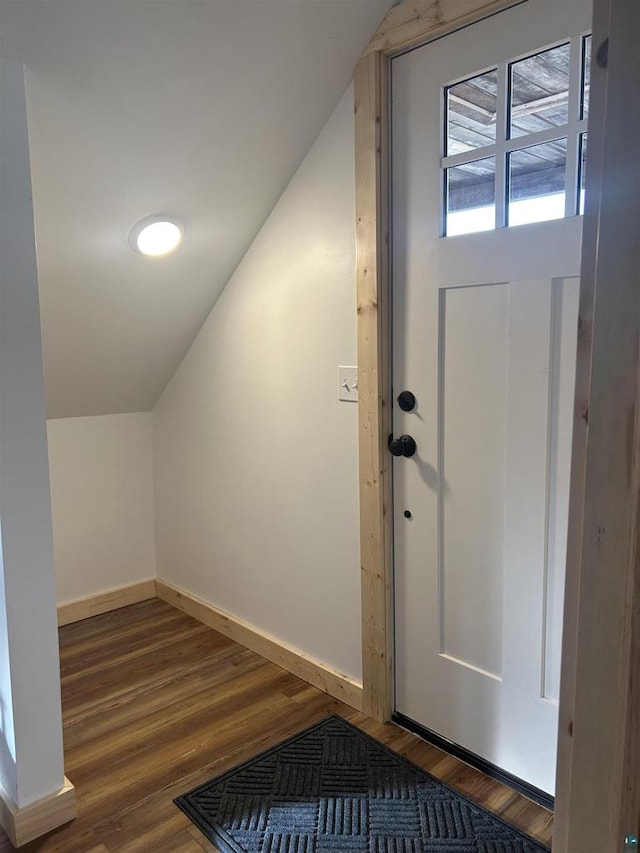 interior space with vaulted ceiling and dark hardwood / wood-style floors