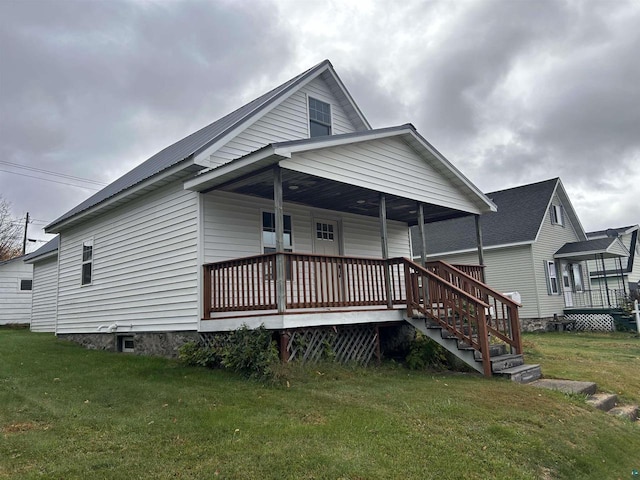 view of front facade with a front yard and a deck