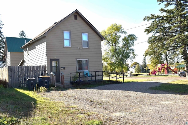 back of house featuring a playground