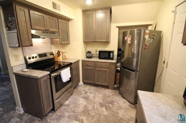 kitchen featuring stainless steel appliances and backsplash