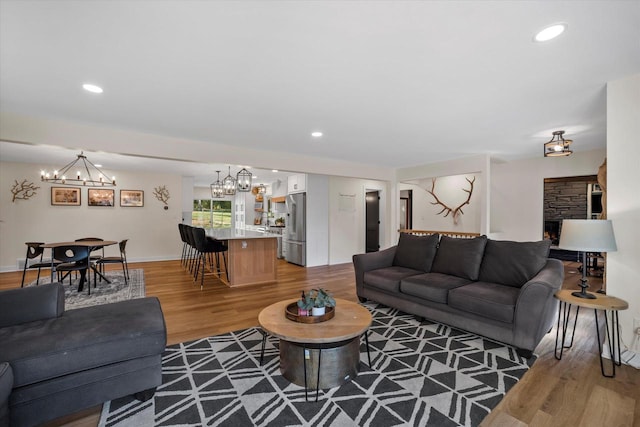 living room featuring wood-type flooring and a chandelier