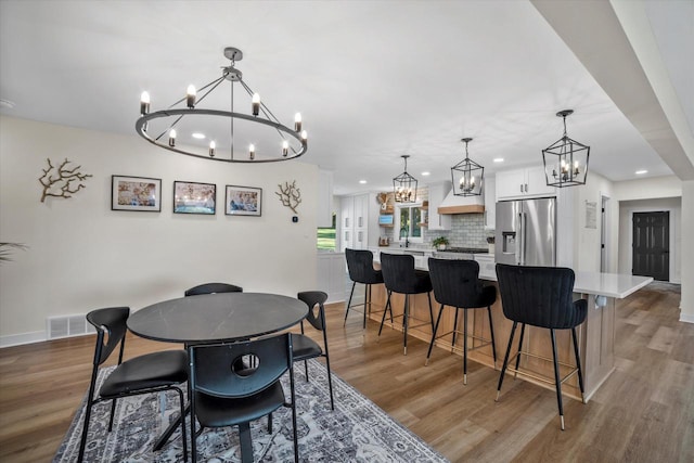 dining space featuring wood-type flooring and sink