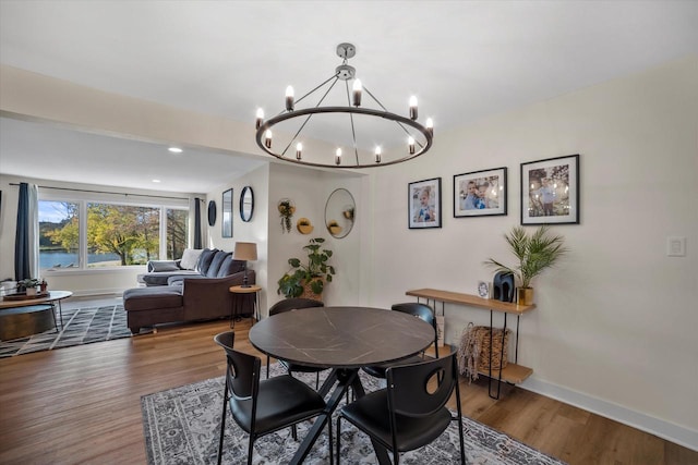 dining area with a notable chandelier and hardwood / wood-style floors