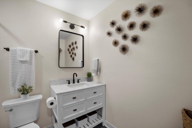 bathroom with toilet and vanity