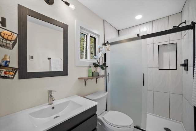 bathroom featuring vanity, toilet, and an enclosed shower