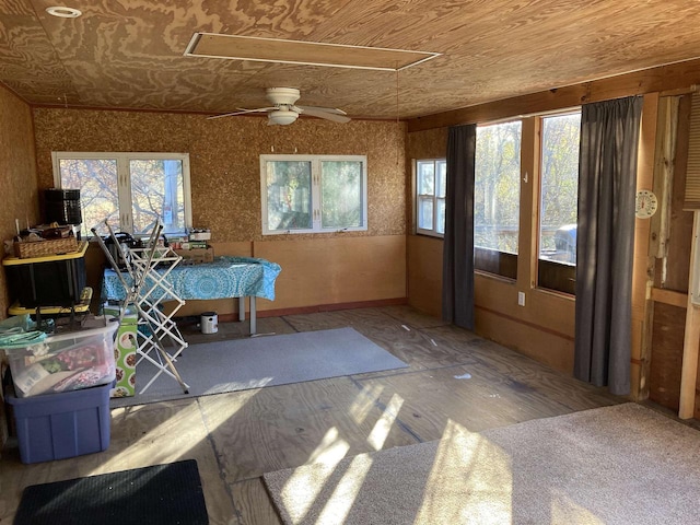 unfurnished sunroom featuring ceiling fan