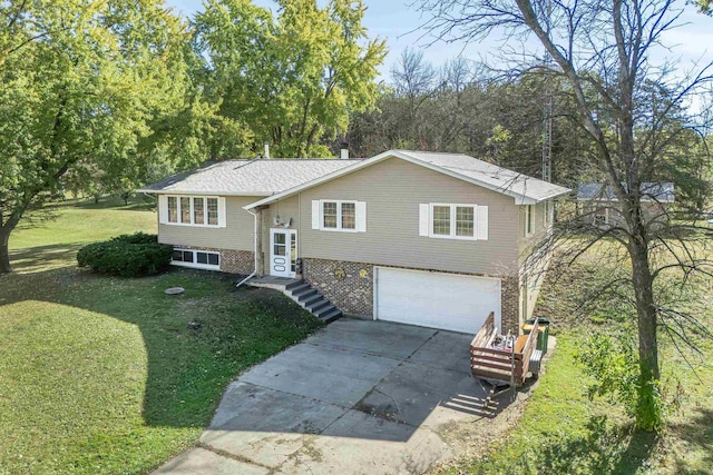 split foyer home featuring a front yard and a garage