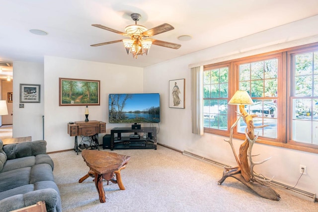 living room featuring ceiling fan, carpet, and a wealth of natural light