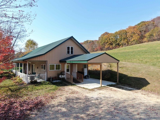 view of front facade featuring a front yard, a carport, and a porch