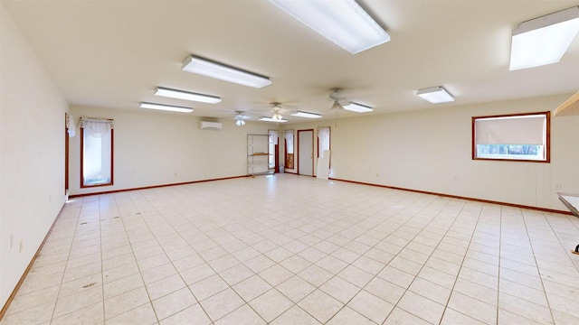 tiled empty room with an AC wall unit and ceiling fan