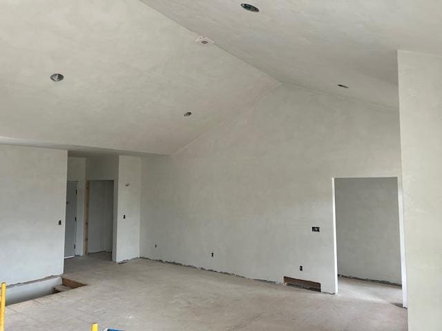 spare room featuring lofted ceiling