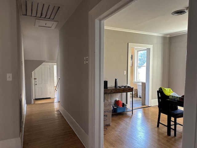 hallway featuring light hardwood / wood-style floors and ornamental molding