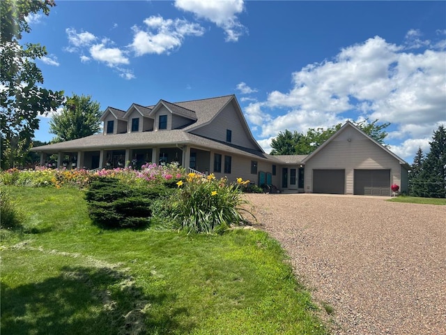 farmhouse with a front yard and a garage