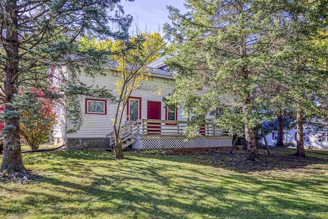 view of front of property featuring a front lawn and a deck