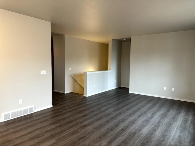 spare room featuring dark wood-type flooring