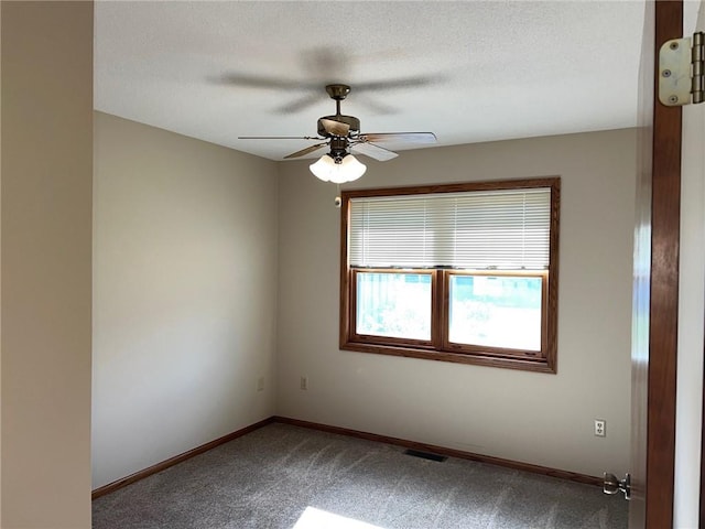 carpeted empty room with a textured ceiling and ceiling fan