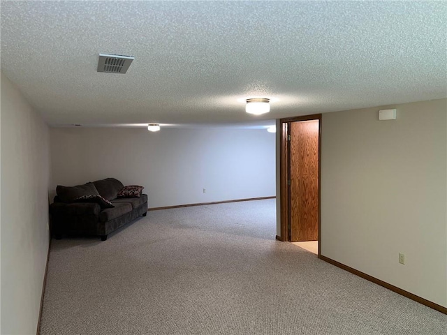 interior space featuring light carpet and a textured ceiling