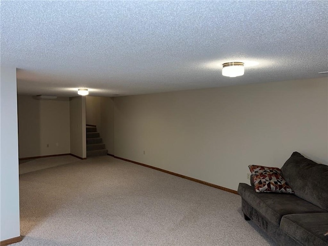 basement featuring a textured ceiling and carpet flooring