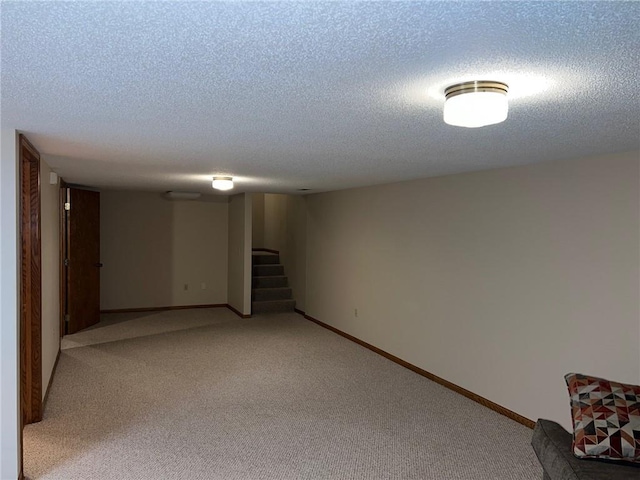 basement with light carpet and a textured ceiling