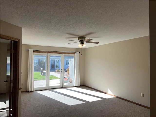 carpeted spare room featuring a textured ceiling and ceiling fan