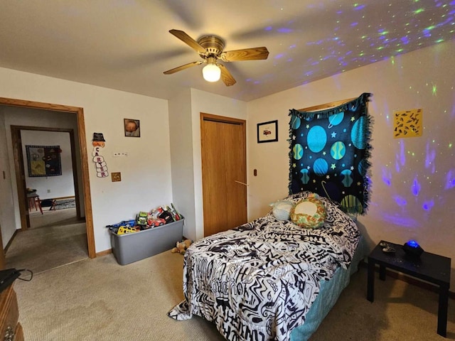 bedroom with a closet, carpet floors, and ceiling fan