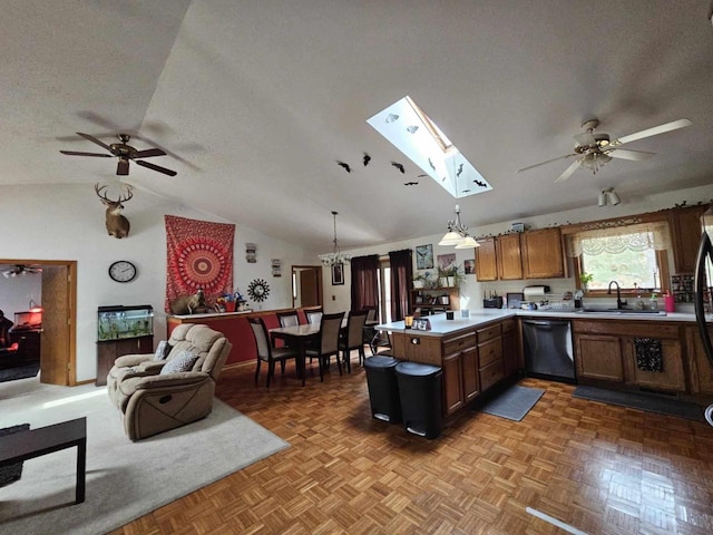 kitchen featuring open floor plan, dishwashing machine, a peninsula, a textured ceiling, and a sink