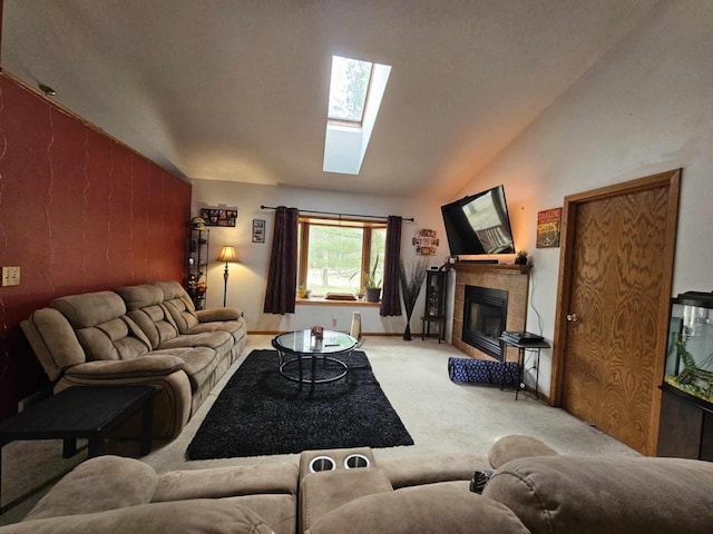 living room featuring a tiled fireplace, lofted ceiling with skylight, and carpet