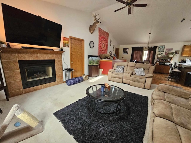 living area with carpet floors, a fireplace, ceiling fan, and vaulted ceiling