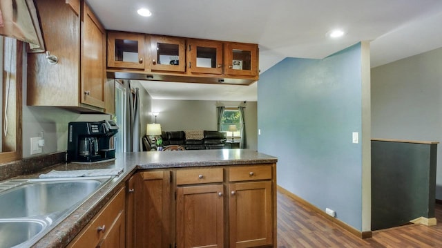 kitchen featuring hardwood / wood-style flooring, sink, and kitchen peninsula