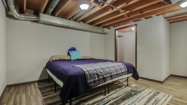 bedroom with hardwood / wood-style floors