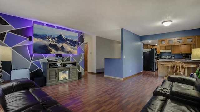 living room featuring indoor bar, a fireplace, and dark hardwood / wood-style flooring