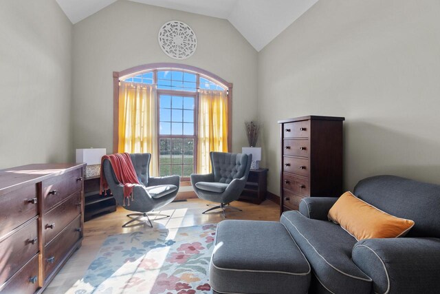 sitting room with vaulted ceiling and light wood-type flooring